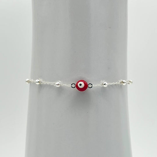 Pulsera de plata 925 con ojo turco rojo central y bolitas facetadas, medida de 16 cm más 5 cm de extensión.